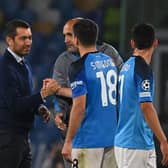 Rangers manager Giovanni van Bronckhorst shakes hands with Napoli striker Giovanni Simeone who struck twice in the 3-0 win. (Photo by ANDREAS SOLARO/AFP via Getty Images)