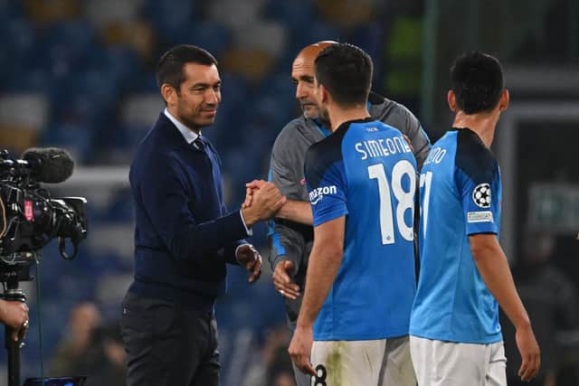 Rangers manager Giovanni van Bronckhorst shakes hands with Napoli striker Giovanni Simeone who struck twice in the 3-0 win. (Photo by ANDREAS SOLARO/AFP via Getty Images)