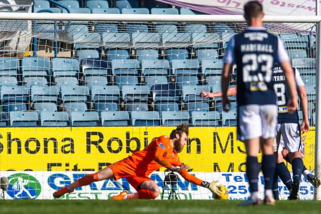 Dundee skipper Charlie Adam's penalty has been tipped onto the post by St Johnstone 'keeper Zander Clark with the ball about to return to the keeper's arms (Photo by Craig Foy / SNS Group)