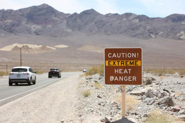 A heat advisory sign is shown along US highway 190 during a heat wave in Death Valley National Park in California.