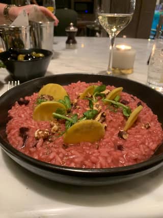 Beetroot risotto with toasted walnuts and discs of parsnip topped with zingy green watercress