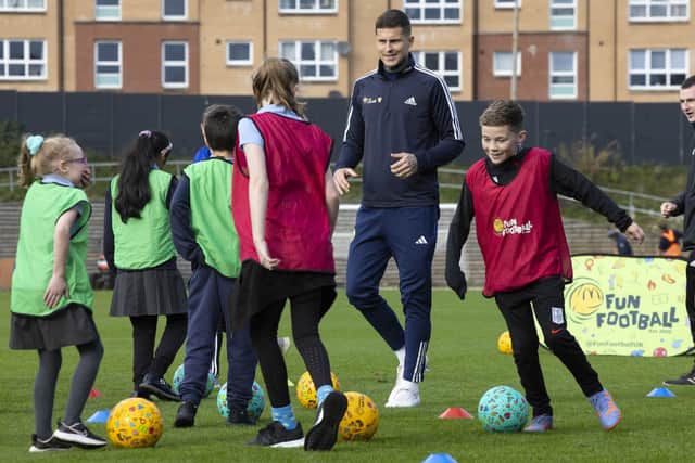Scotland International Lyndon Dykes probably telling youngsters goalkeeping tale tales during McDonald's Fun Football event at Lesser Hampden this week. (Photo by Ross MacDonald / SNS Group)
