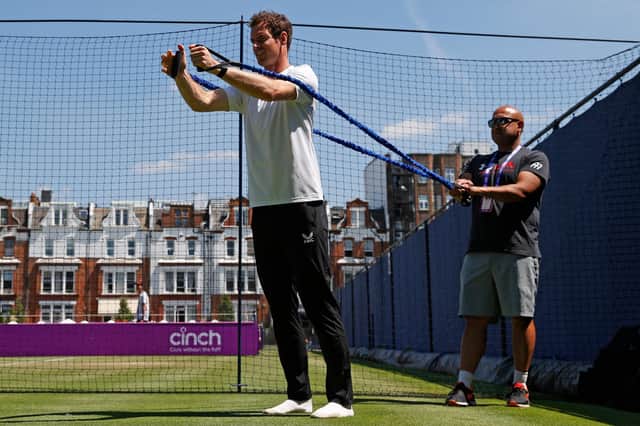 Andy Murray does stretching exercises as he practises ahead of today’s first-round match against France’s Benoit Paire