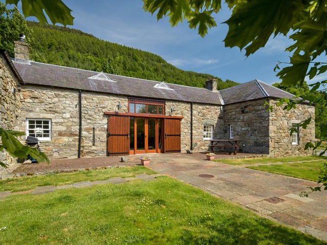 The pair later purchased the steading situated to the rear of the former manse and converted it into a beautiful two-bedroom home, with a main room entitled The Great Hall, which features a high wood-panelled ceiling, under-floor heating, and an imposing stone fireplace.
