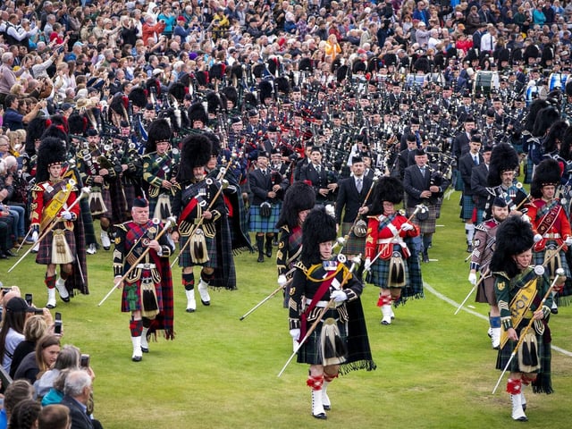 The Massed Pipes and Drums parade in the arena during the Braemar Royal Highland Gathering