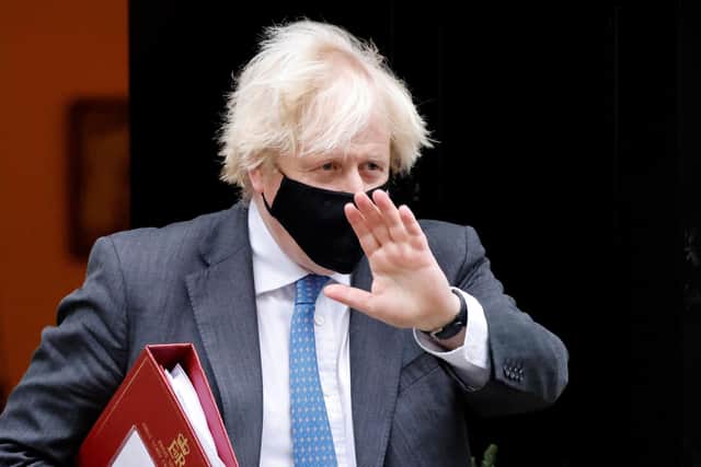 Prime Minister Boris Johnson, wearing a face covering to stop the spread of coronavirus, waves as he leaves from 10 Downing Street in central London. Picture: Tolga Akmen/AFP via Getty Images