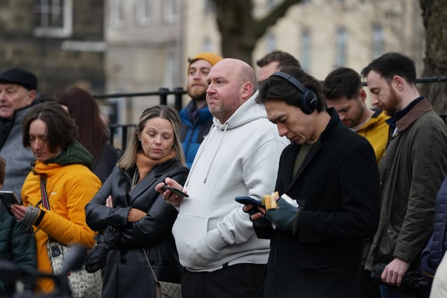Members of the public outside Bute House in Edinburgh watching the press conference where First Minister Nicola Sturgeon announced she will stand down as First Minister for Scotland after eight years.