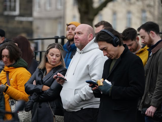 Members of the public outside Bute House in Edinburgh watching the press conference where First Minister Nicola Sturgeon announced she will stand down as First Minister for Scotland after eight years.