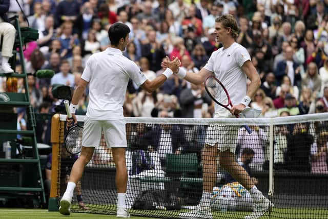 Serbia's Novak Djokovic shakes hands with South Africa's Kevin Anderson, after winning the men's singles second round match on day three of the Wimbledon Tennis Championships in London, Wednesday June 30, 2021. (AP Photo/Alastair Grant)