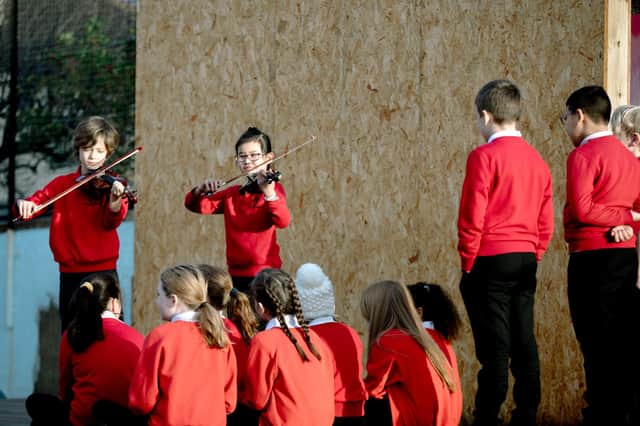 Harris Hawkey and Luo Lin Zheng perform for pupils at Hermitage Park Primary School in Leith today to launch the new initiative. Picture: Ryan Buchanan
