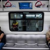 A television (top) on a train in Hong Kong on August 5, 2022, shows military exercises being held by China around the island of Taiwan. (Photo by ISAAC LAWRENCE / AFP) (Photo by ISAAC LAWRENCE/AFP via Getty Images)