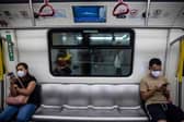 A television (top) on a train in Hong Kong on August 5, 2022, shows military exercises being held by China around the island of Taiwan. (Photo by ISAAC LAWRENCE / AFP) (Photo by ISAAC LAWRENCE/AFP via Getty Images)