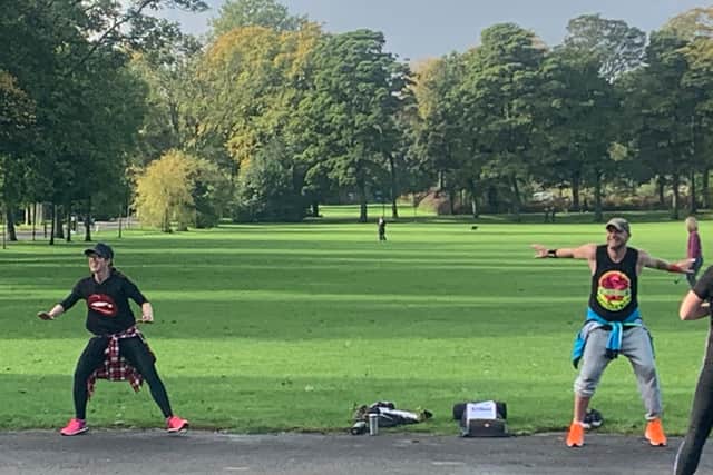 At a distance: Zumba instructors Alex Bettencourt and Fergus McNicol lead an outdoor class at Inverleith Park, Edinburgh, during a lift in lockdown.