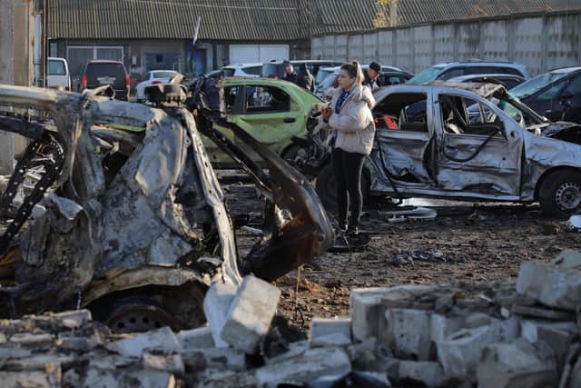 People inspect cars destroyed at a service station following an air attack on Odesa in Ukraine yesterday  (Picture: Oleksandr Gimanov/AFP via Getty)