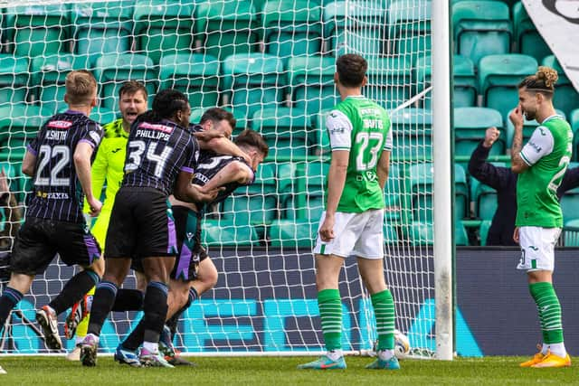 St Johnstone's Tony Gallacher celebrates as the Hibs players look on disconsolately.