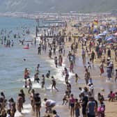 People enjoying the warm weather on Bournemouth beach in Dorset. The boom of cheap package holidays in the 1960s has been linked to a rise in a serious type of skin cancer among older adults, charity Cancer Research UK has suggested. Picture: Andrew Matthews/PA Wire