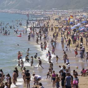 People enjoying the warm weather on Bournemouth beach in Dorset. The boom of cheap package holidays in the 1960s has been linked to a rise in a serious type of skin cancer among older adults, charity Cancer Research UK has suggested. Picture: Andrew Matthews/PA Wire