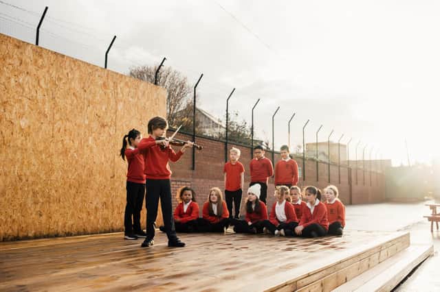 Harris Hawkey and Luo Lin Zheng perform on a new outdoor stage at Hermitage Park Primary in Leith which has been provided by the Edinburgh International Festival. (Picture: Ryan Buchanan)