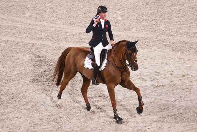 British gold medallist Ben Maher, on board Explosion W, shows off his gold medal after being crowned Olympic showjumping champion. Picture: Ezra Shaw/Getty Images