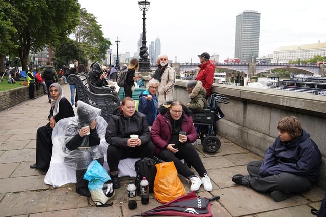 Members of the public join the queue on the South Bank, as they wait to view the coffin of Queen Elizabeth II lying in state ahead of her funeral on Monday. Picture date: Wednesday September 14, 2022.