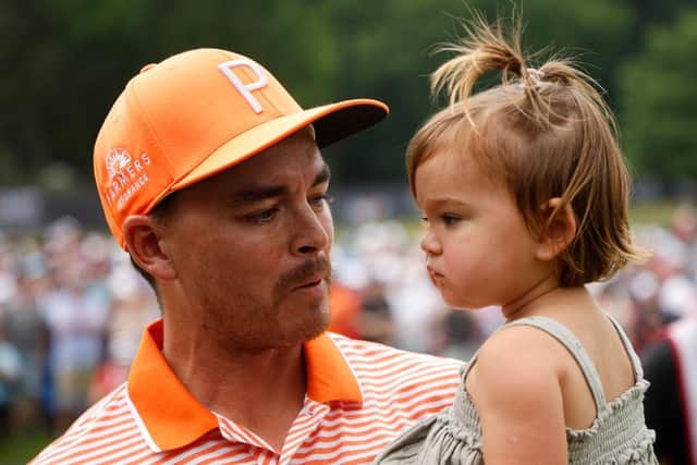 Rickie Fowler celebrates with his daughter, Maya, after winning the Rocket Mortgage Classic in a play-off at Detroit Golf Club. PIcture: Cliff Hawkins/Getty Images.