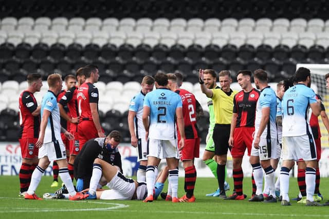 A historical, pre-woke image of St Mirren and Ross County engaging in handbags when doubtless some of the Buddies thought the County man on the ground was being a drama queen.