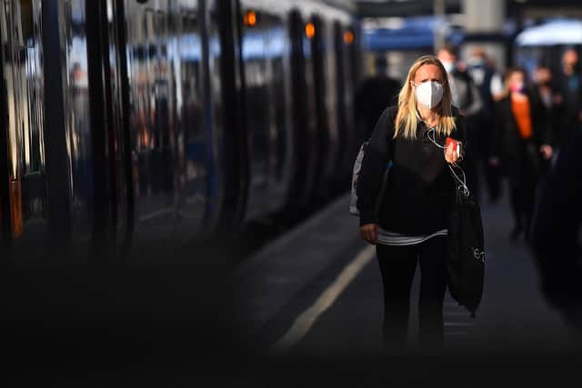 A passenger wearing a face mask after disembarking off a train. Picture: Victoria Jones/PA Wire