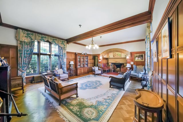 Interior: A welcoming wood-panelled entrance hall boasts a feature fireplace and leads to a drawing room, billiards room, and kitchen. A sitting room and all six bedrooms are located on the first floor.