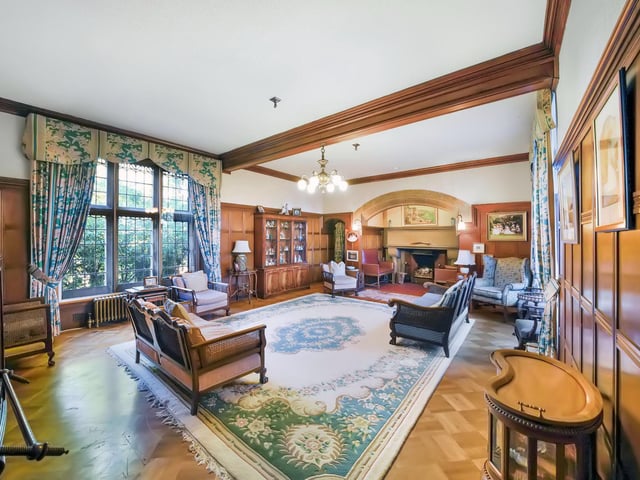 Interior: A welcoming wood-panelled entrance hall boasts a feature fireplace and leads to a drawing room, billiards room, and kitchen. A sitting room and all six bedrooms are located on the first floor.