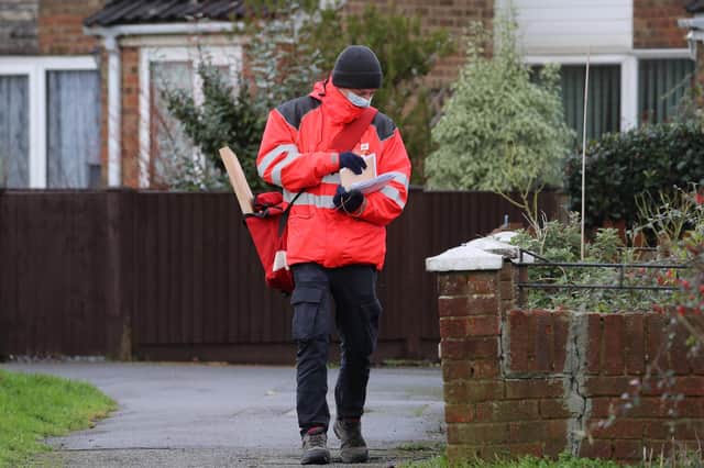 A Royal Mail delivery worker.