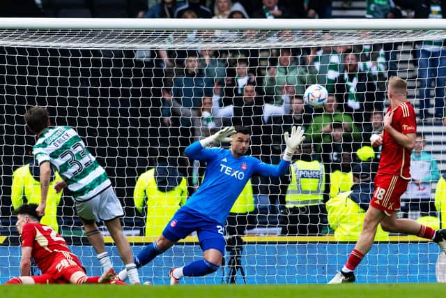 Matt O'Riley fires the ball high past Kelle Roos to put Celtic 3-2 up against Aberdeen at Hampden.