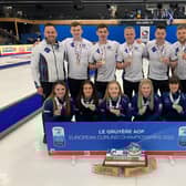 Team Scotland show off their gold medals alongside the women's team/