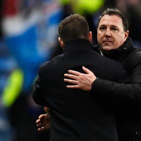Ross County manager Malky Mackay embraces Rangers counterpart Michael Beale after the 2-1 defeat at Ibrox. (Photo by Rob Casey / SNS Group)