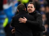 Ross County manager Malky Mackay embraces Rangers counterpart Michael Beale after the 2-1 defeat at Ibrox. (Photo by Rob Casey / SNS Group)