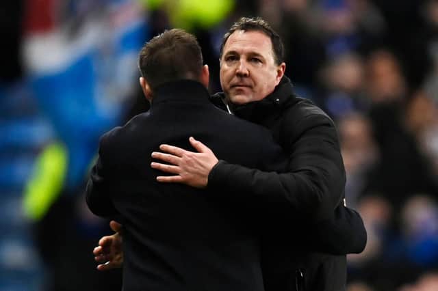 Ross County manager Malky Mackay embraces Rangers counterpart Michael Beale after the 2-1 defeat at Ibrox. (Photo by Rob Casey / SNS Group)