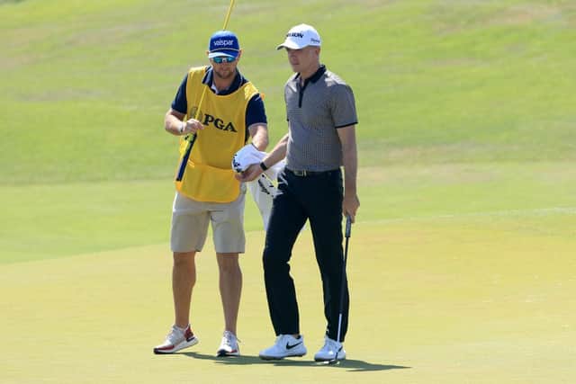 Martin Laird is handed his ball by fellow Sco Kevin McAlpine as he prepares to putt on the 17th hole during the second round of the 2021 PGA Championship at Kiawah Island. Picture: Sam Greenwood/Getty Images.
