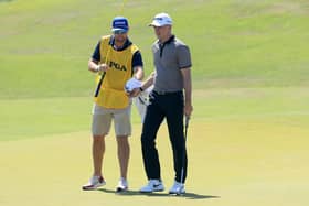 Martin Laird is handed his ball by fellow Sco Kevin McAlpine as he prepares to putt on the 17th hole during the second round of the 2021 PGA Championship at Kiawah Island. Picture: Sam Greenwood/Getty Images.