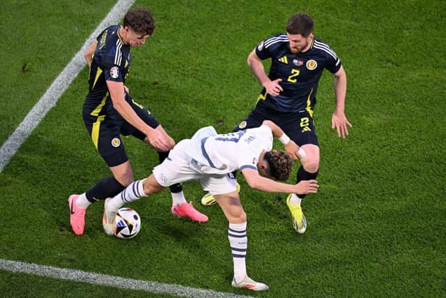 Scotland team-mates Jack Hendry and Anthony Ralston combine to thwart Switzerland's Ruben Vargas. (Photo by KIRILL KUDRYAVTSEV/AFP via Getty Images)