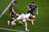 Scotland team-mates Jack Hendry and Anthony Ralston combine to thwart Switzerland's Ruben Vargas. (Photo by KIRILL KUDRYAVTSEV/AFP via Getty Images)