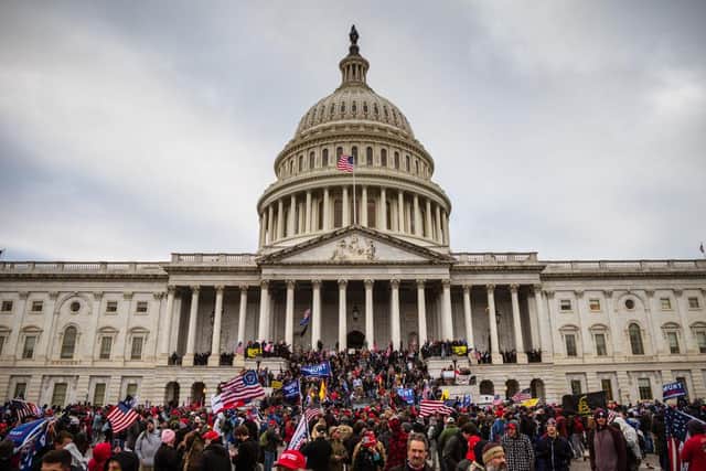Five people were killed, including one police officer, during extraordinary scenes at the US Capitol building on Wednesday, when an armed mob of pro-Trump supporters broke through security barriers and plunged a joint session of Congress into chaos. (Photo by Jon Cherry/Getty Images)