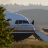 A man stands on the steps of the grounded Rwanda deportation flight EC-LZO Boeing 767 at Boscombe Down Air Base. The flight taking asylum seekers from the UK to Rwanda was grounded at the last minute after intervention of the European Court of Human Rights. Picture: Getty Images