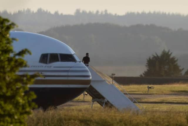 A man stands on the steps of the grounded Rwanda deportation flight EC-LZO Boeing 767 at Boscombe Down Air Base. The flight taking asylum seekers from the UK to Rwanda was grounded at the last minute after intervention of the European Court of Human Rights. Picture: Getty Images