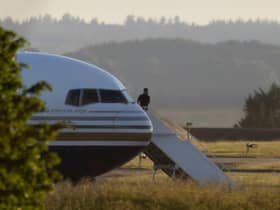A man stands on the steps of the grounded Rwanda deportation flight EC-LZO Boeing 767 at Boscombe Down Air Base. The flight taking asylum seekers from the UK to Rwanda was grounded at the last minute after intervention of the European Court of Human Rights. Picture: Getty Images