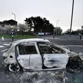 Burnt out cars can be seen at the Cloughfern roundabout junction following overnight Loyalist violence on April 4, 2021 in Belfast, Northern Ireland. Loyalist unrest and disorder in the province continues as a result of the implementation of the so called Irish sea border.