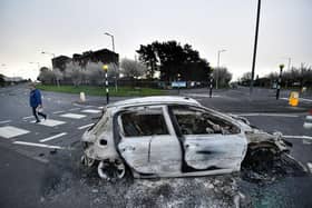 Burnt out cars can be seen at the Cloughfern roundabout junction following overnight Loyalist violence on April 4, 2021 in Belfast, Northern Ireland. Loyalist unrest and disorder in the province continues as a result of the implementation of the so called Irish sea border.
