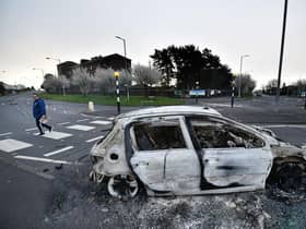 Burnt out cars can be seen at the Cloughfern roundabout junction following overnight Loyalist violence on April 4, 2021 in Belfast, Northern Ireland. Loyalist unrest and disorder in the province continues as a result of the implementation of the so called Irish sea border.