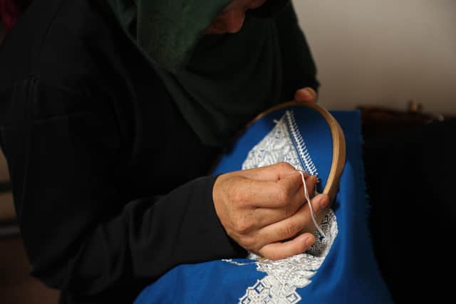 Ferhana, working in her clothes shop in Kabul.