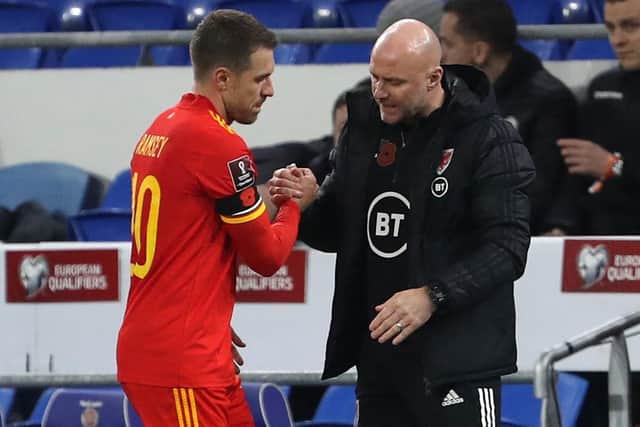 Wales' interim head coach Rob Page (R) shakes hands with Wales' midfielder Aaron Ramsey (L) as he's substituted during the FIFA World Cup 2022 Group E qualifier football match between Wales and Belarus at Cardiff City Stadium in Cardiff, south Wales on November 13, 2021. (Photo by GEOFF CADDICK/AFP via Getty Images)