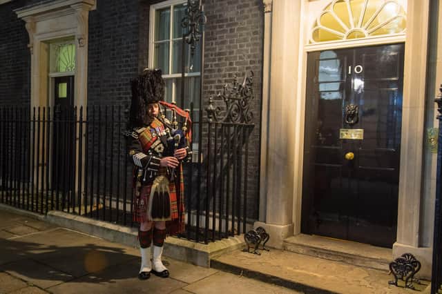 A piper of the Scots Guards plays outside 10 Downing Street, London, to welcome guests to a Burns' Night supper (Picture: Dominic Lipinski/PA)