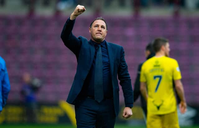 Ross County manager Malky Mackay salutes the travelling fans after a draw with Hearts.